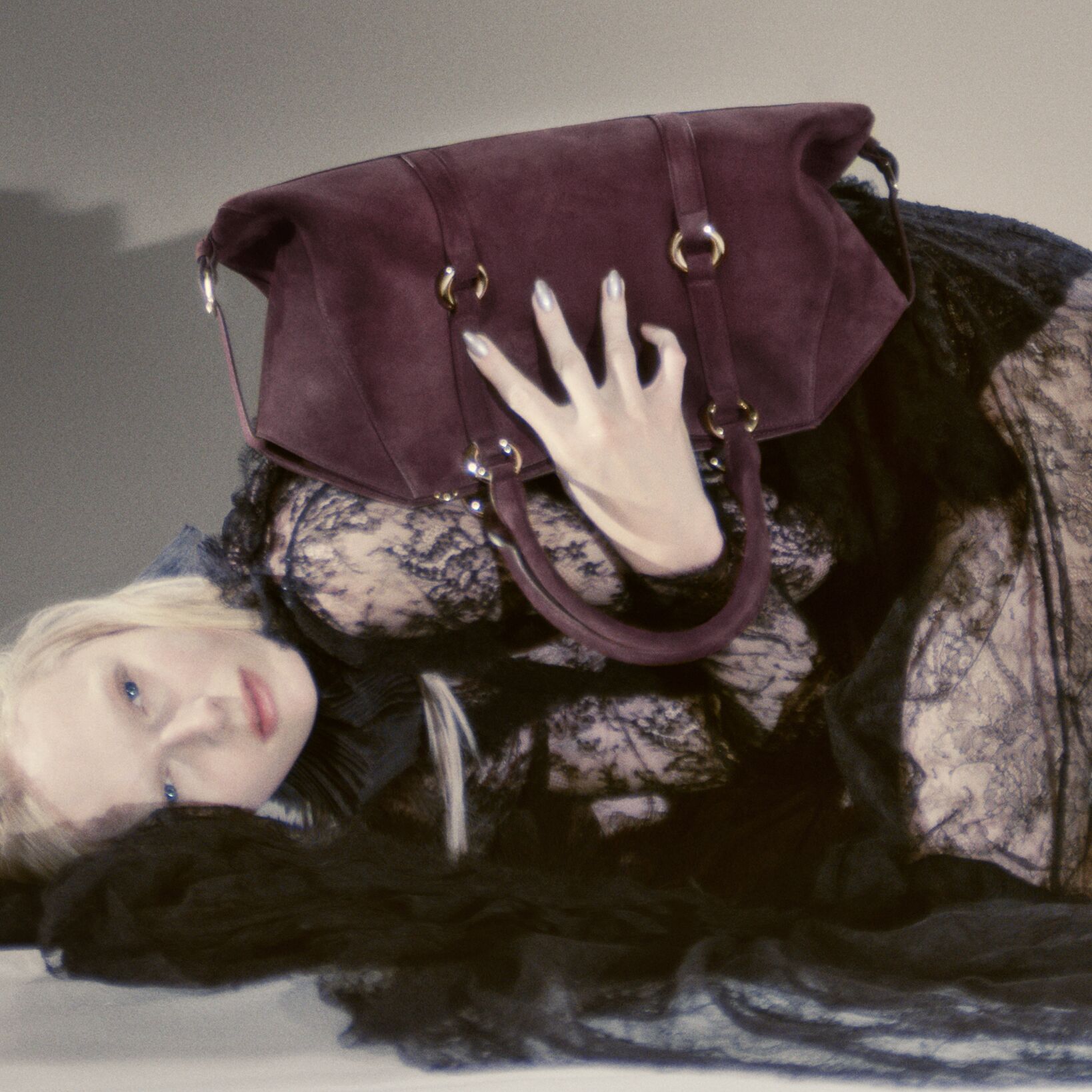 Women holding a McQueen Farringdon Bag